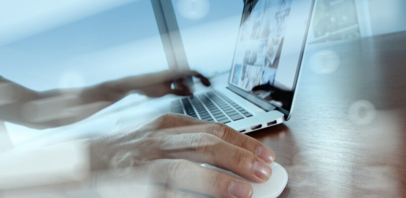 double exposure of business man hand working on laptop computer on wooden desk as concept